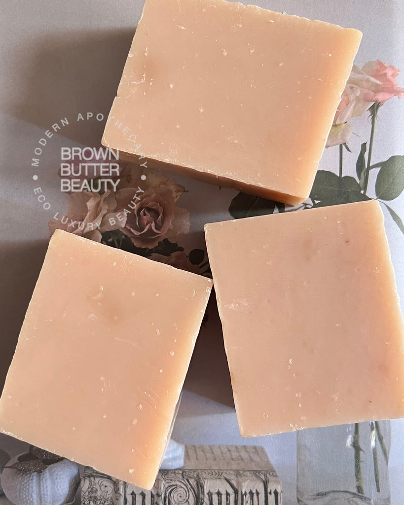 Three rosee soap bars on a surface with 'Brown Butter Beauty' branding in the background.